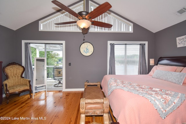 bedroom featuring multiple windows, hardwood / wood-style floors, access to outside, and ceiling fan