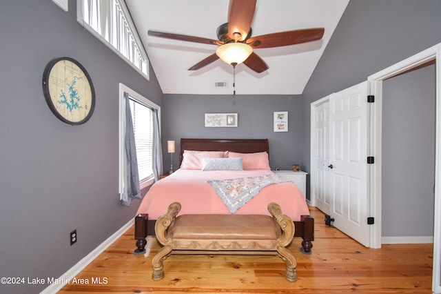 bedroom with hardwood / wood-style flooring, ceiling fan, and high vaulted ceiling