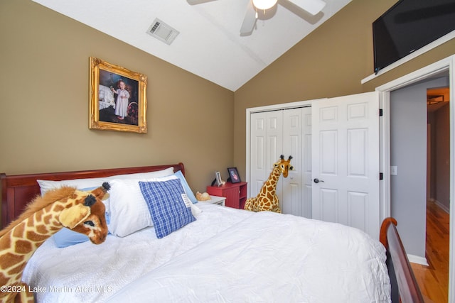 bedroom featuring ceiling fan, vaulted ceiling, wood-type flooring, and a closet