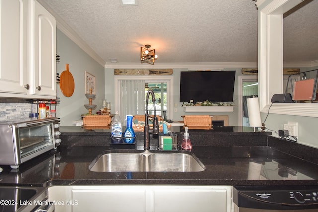 kitchen featuring white cabinets, stainless steel dishwasher, ornamental molding, and sink