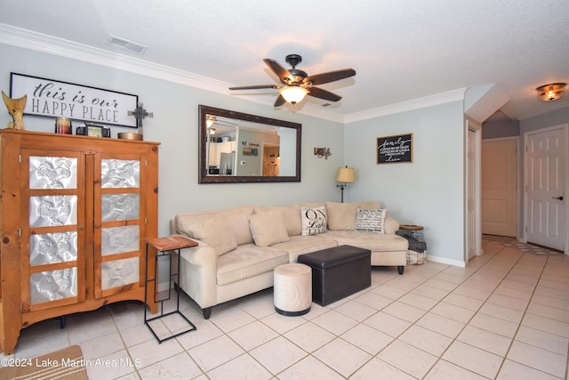 living room with ceiling fan, ornamental molding, a textured ceiling, and light tile patterned floors