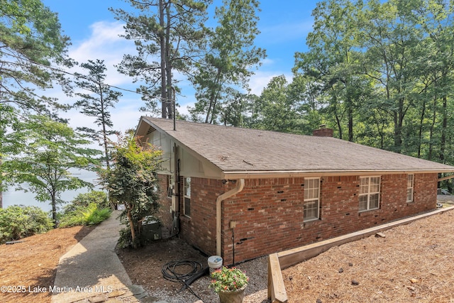 195 Honeysuckle Hl, Tallassee, AL 36078 - view of property exterior with brick siding, a chimney, and a shingled roof