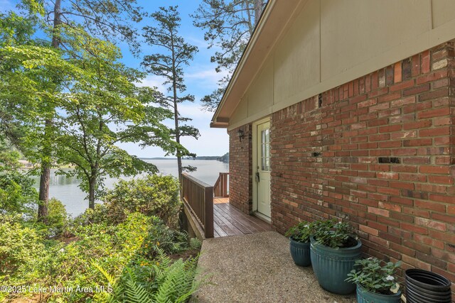 195 Honeysuckle Hl, Tallassee, AL 36078 - view of side of property with a deck with water view and brick siding