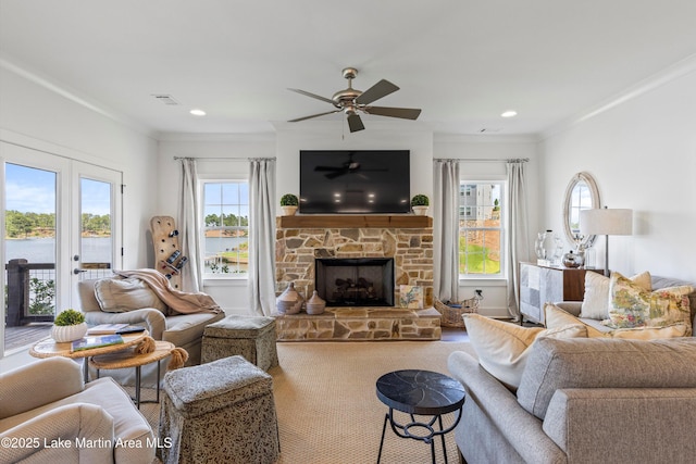 20 Heart Pine Ln, Dadeville, AL 36853 - carpeted living room with a stone fireplace, ceiling fan, crown molding, and recessed lighting