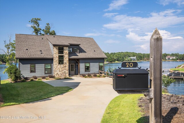 20 Heart Pine Ln, Dadeville, AL 36853 - view of front of property featuring a shingled roof, a water view, a front yard, and driveway