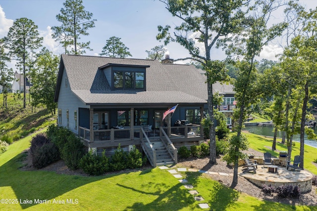 20 Heart Pine Ln, Dadeville, AL 36853 - view of front of property featuring an outdoor fire pit, a front lawn, stairs, a shingled roof, and a chimney