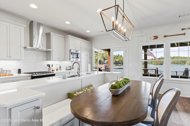 20 Heart Pine Ln, Dadeville, AL 36853 - kitchen with wall chimney range hood, appliances with stainless steel finishes, tasteful backsplash, ornamental molding, and light countertops