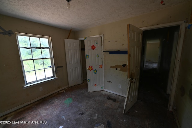 382 Daniel Rd, Kellyton, AL 35089 - unfurnished bedroom with multiple windows and a textured ceiling