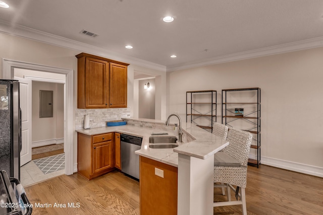 48 Stoneview Summit Ct Unit 2401, Dadeville, AL 36853 - kitchen with appliances with stainless steel finishes, a sink, a peninsula, a breakfast bar, and brown cabinetry