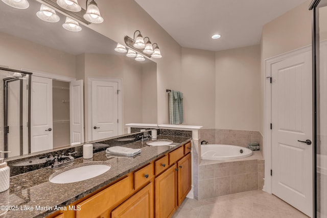 48 Stoneview Summit Ct Unit 2401, Dadeville, AL 36853 - bathroom with a garden tub, tile patterned flooring, a closet, double vanity, and recessed lighting