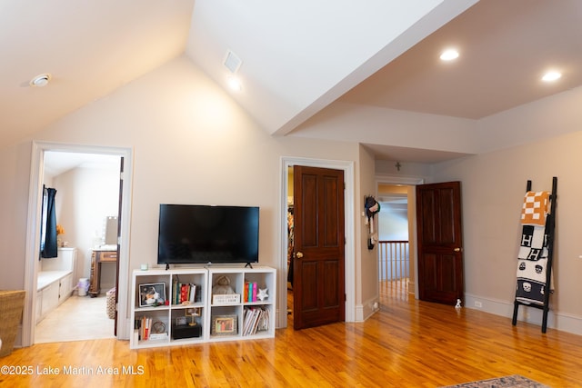 6261 Thach Rd, Montgomery, AL 36117 - living room featuring lofted ceiling, recessed lighting, baseboards, visible vents, and wood finished floors