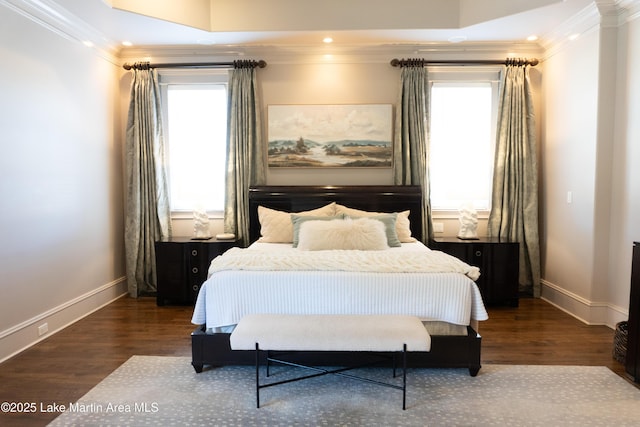 bedroom featuring baseboards, multiple windows, and wood finished floors