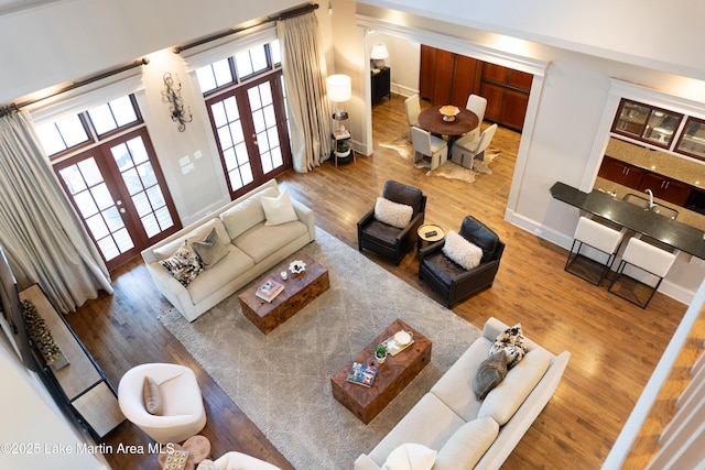 living room featuring baseboards, french doors, and wood finished floors