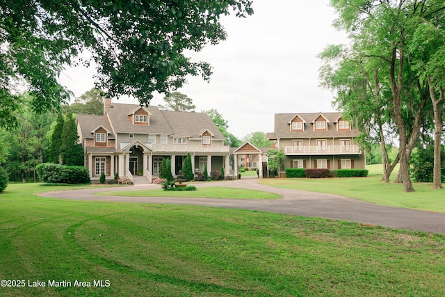 6261 Thach Rd, Montgomery, AL 36117 - view of front of home with a chimney, aphalt driveway, and a front lawn