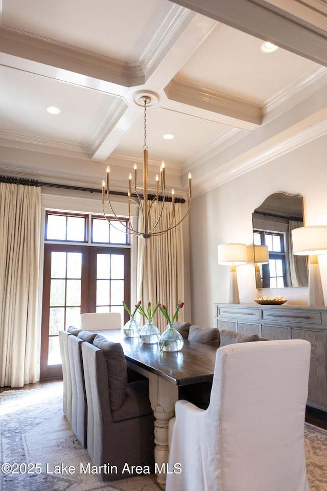 dining area with a healthy amount of sunlight, crown molding, beam ceiling, an inviting chandelier, and coffered ceiling