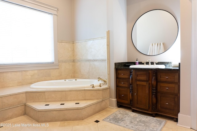 bathroom featuring a garden tub, tile patterned floors, and vanity