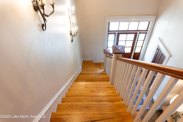 stairs with baseboards and wood finished floors
