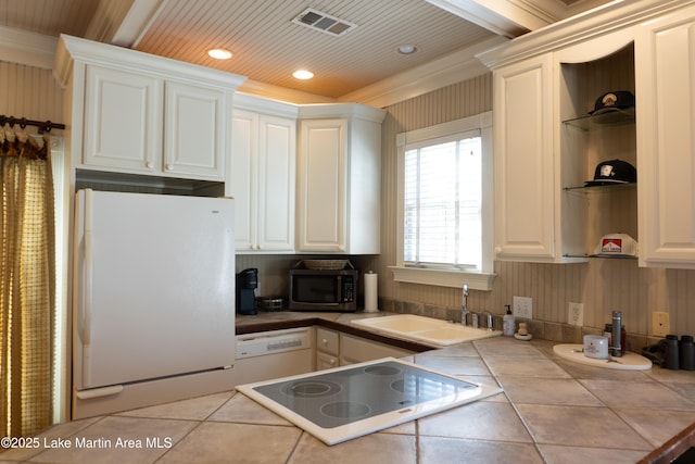 kitchen featuring tile countertops, visible vents, open shelves, a sink, and white appliances