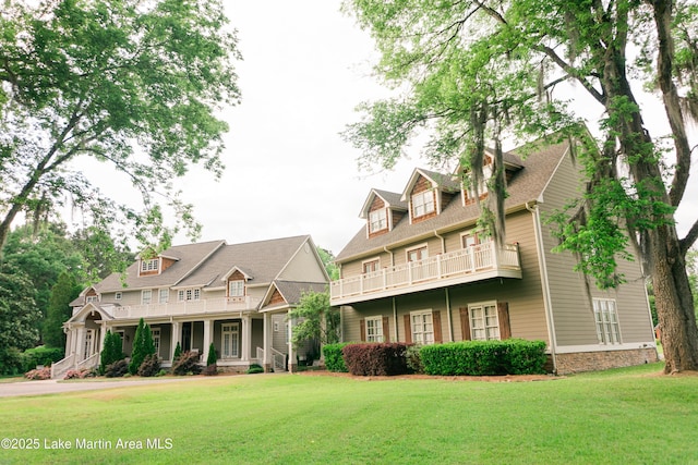 back of house with a lawn, a balcony, and a porch