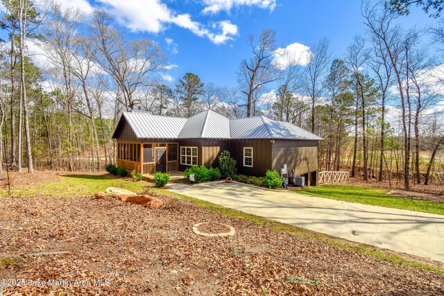 view of front of home featuring metal roof and a sunroom
