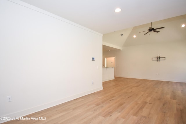 spare room featuring recessed lighting, ceiling fan, light wood finished floors, and vaulted ceiling