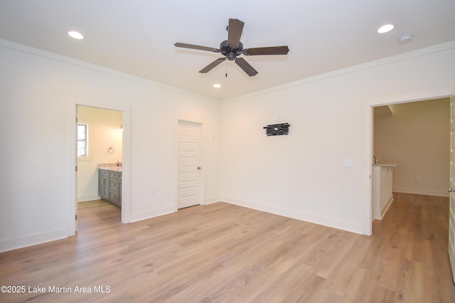 unfurnished bedroom featuring light wood-style floors, crown molding, baseboards, and recessed lighting