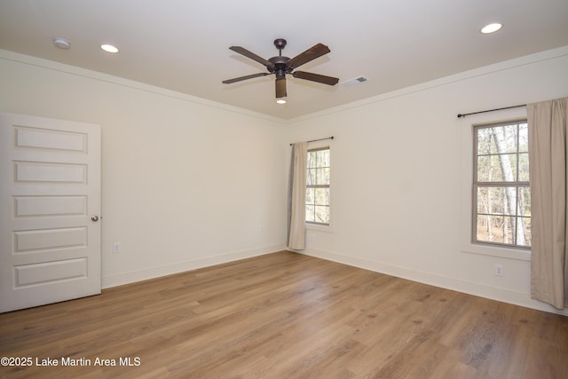 unfurnished room with visible vents, a ceiling fan, ornamental molding, and a healthy amount of sunlight