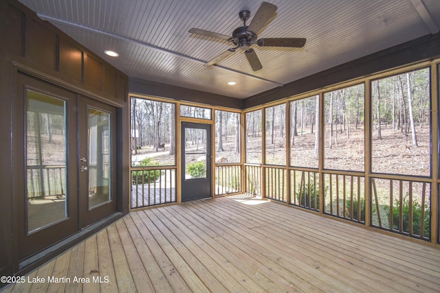 unfurnished sunroom featuring french doors, a ceiling fan, and a healthy amount of sunlight