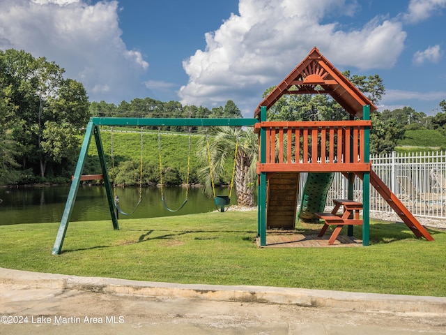 view of jungle gym featuring a lawn and a water view