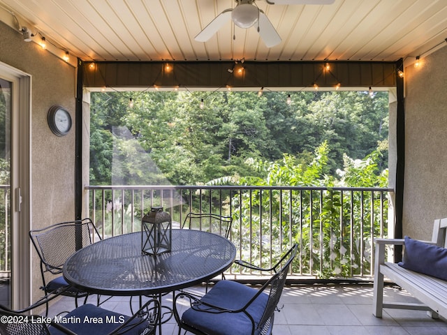 sunroom featuring ceiling fan and wood ceiling