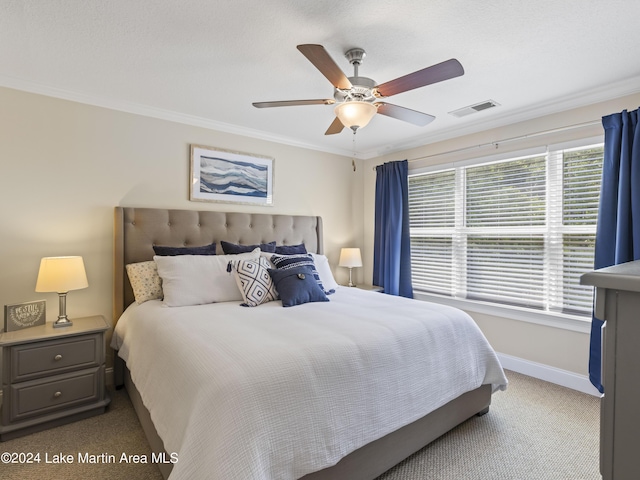 carpeted bedroom featuring ceiling fan and crown molding