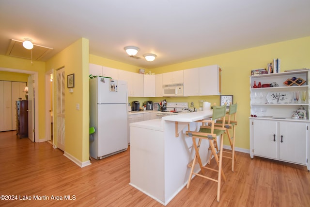 kitchen featuring white appliances and white cabinets