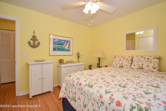 bedroom featuring a closet, light hardwood / wood-style flooring, and ceiling fan