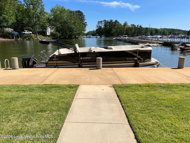 dock area with a lawn and a water view