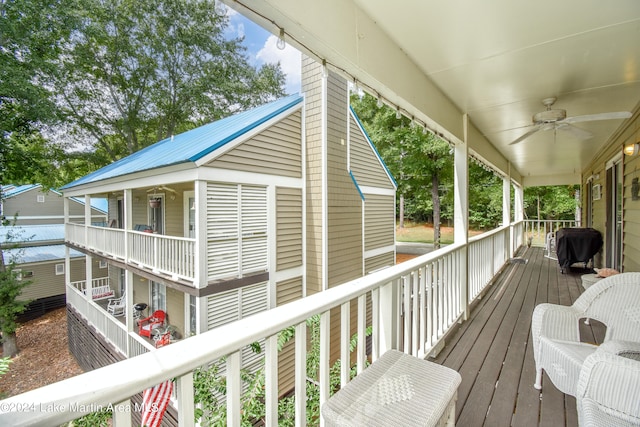 wooden deck with grilling area and ceiling fan