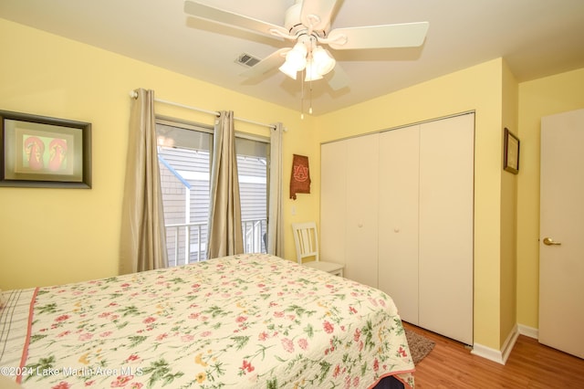 bedroom with ceiling fan, a closet, and light hardwood / wood-style flooring