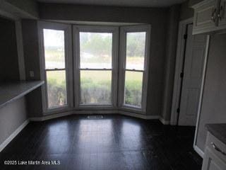 1415 Lee Road 219, Phenix City, AL 36870 - unfurnished dining area featuring baseboards and dark wood-type flooring