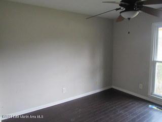 1415 Lee Road 219, Phenix City, AL 36870 - unfurnished room featuring a ceiling fan, healthy amount of natural light, and dark wood-type flooring