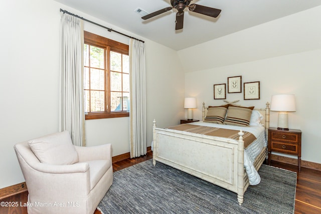 bedroom featuring dark hardwood / wood-style flooring, vaulted ceiling, and ceiling fan