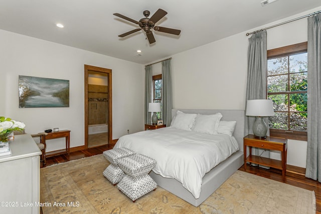 bedroom with wood-type flooring and connected bathroom