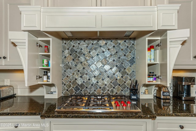 kitchen featuring white cabinetry, dark stone counters, and stainless steel gas cooktop