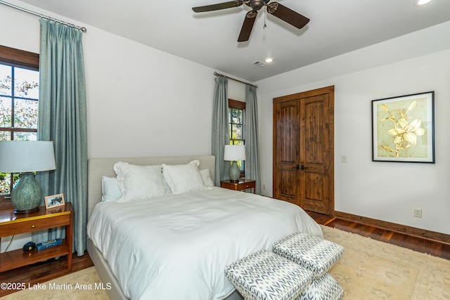 bedroom featuring wood-type flooring, a closet, and ceiling fan