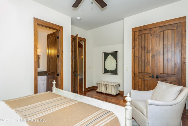 bedroom with hardwood / wood-style flooring, ceiling fan, and ensuite bath