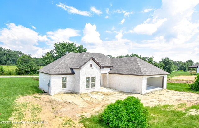 63 Noles Dr, Tallassee, AL 36078 - french country inspired facade with brick siding, a garage, a front yard, and roof with shingles