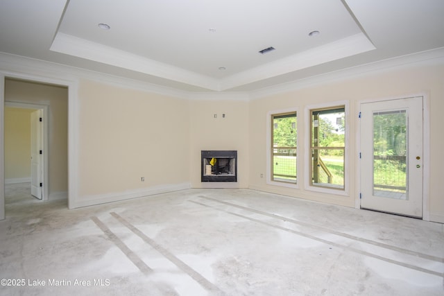 63 Noles Dr, Tallassee, AL 36078 - unfurnished living room featuring a raised ceiling, concrete flooring, a fireplace, and ornamental molding