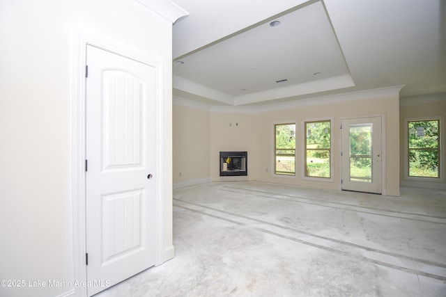 63 Noles Dr, Tallassee, AL 36078 - unfurnished living room with a raised ceiling, a fireplace, healthy amount of natural light, crown molding, and concrete flooring