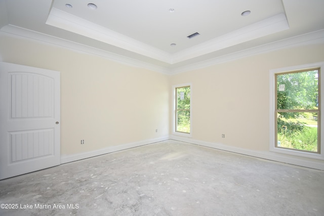 63 Noles Dr, Tallassee, AL 36078 - spare room featuring a tray ceiling, concrete flooring, and crown molding