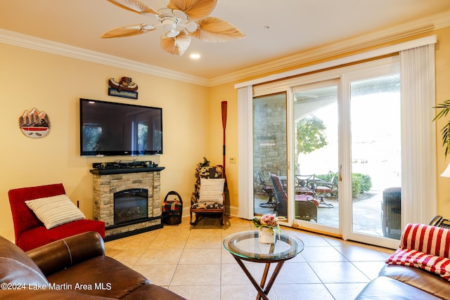 living room featuring a fireplace, light tile patterned flooring, crown molding, and ceiling fan