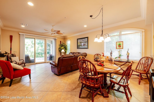 dining space featuring ceiling fan with notable chandelier, crown molding, and a wealth of natural light