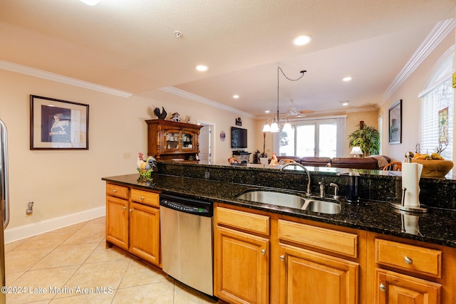 kitchen with dishwasher, dark stone countertops, sink, and decorative light fixtures